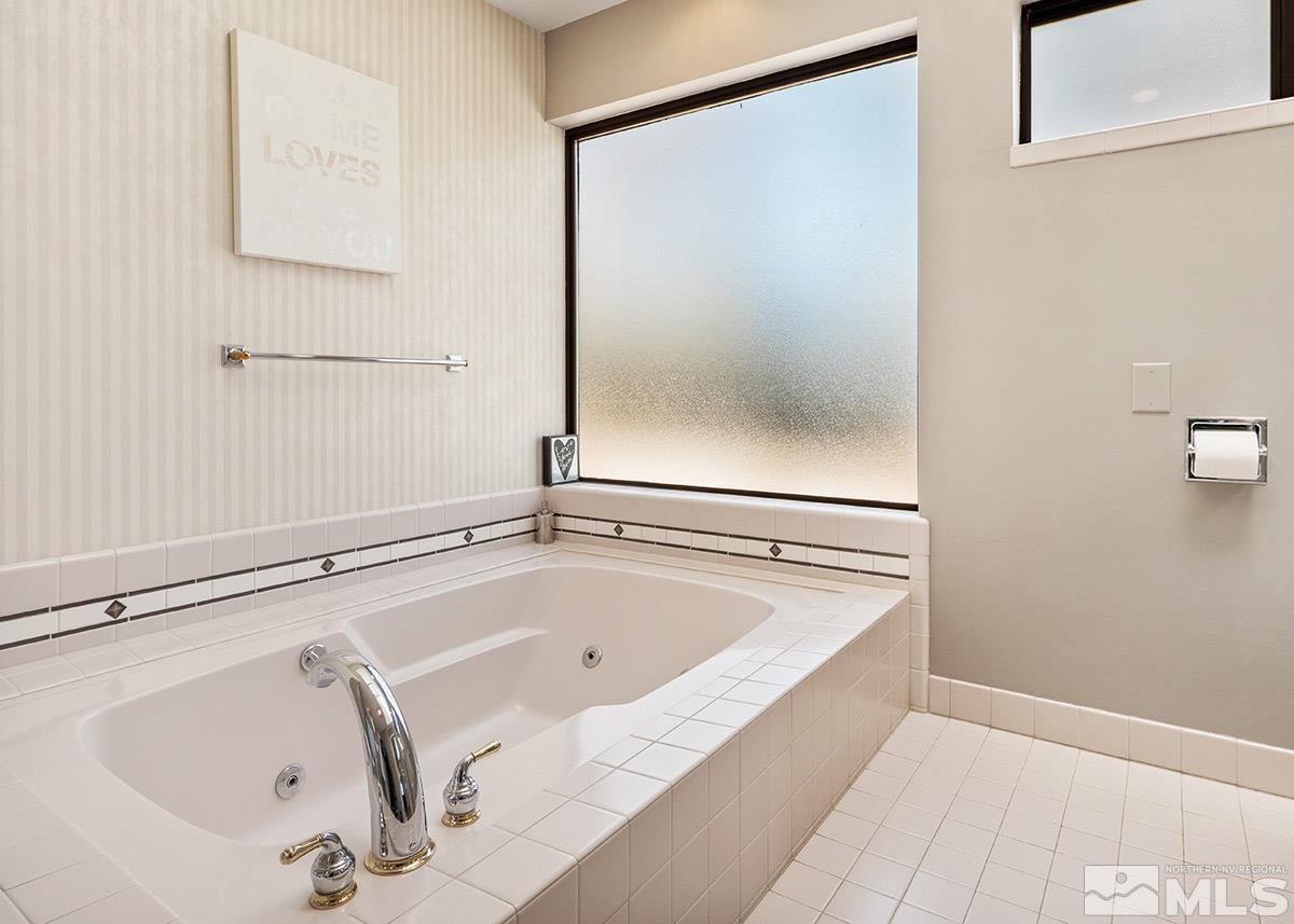 2215 Hedgewood Drive Reno, NV 89509 - Photo 25 of 39 a bathroom with a tub and a shower