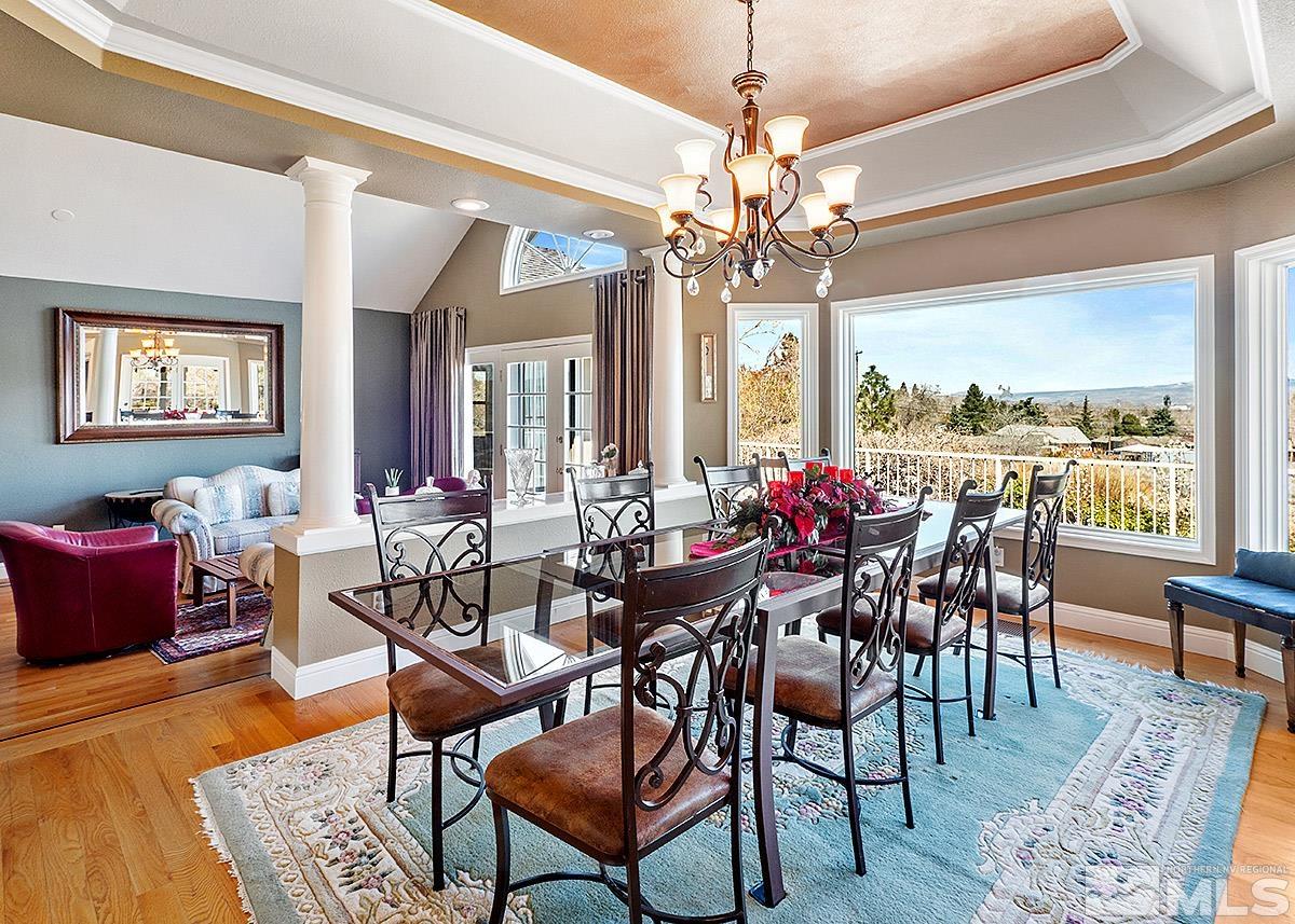 2215 Hedgewood Drive Reno, NV 89509 - Photo 6 of 39 a view of a dining room with furniture a chandelier and wooden floor