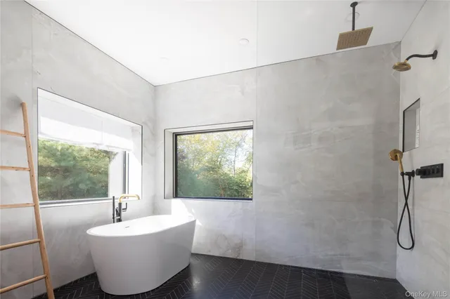 a living room with a bathtub and a window