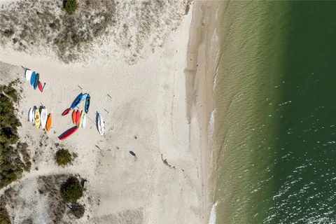 a front view of a house with a garden and trees