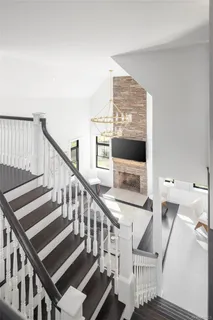 a view of staircase with lots of wooden floor and windows