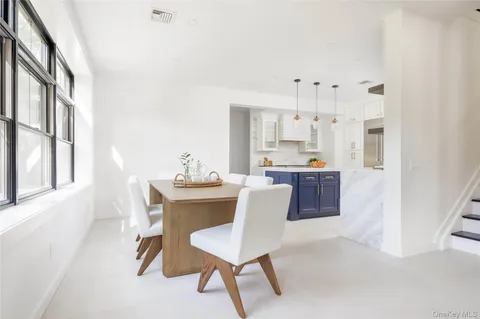 a living room with kitchen island furniture and a chandelier