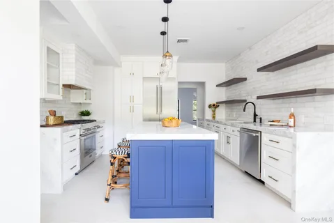 a kitchen with kitchen island granite countertop wooden cabinets and white appliances