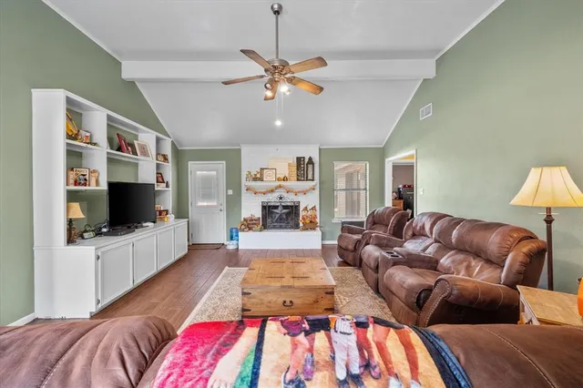 a living room with furniture a fireplace and a chandelier