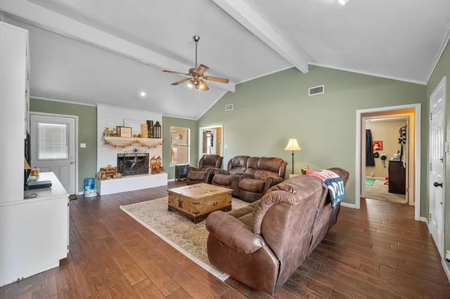 a livingroom with a fireplace and a flat screen tv