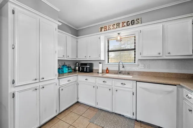 a kitchen with white cabinets and white appliances