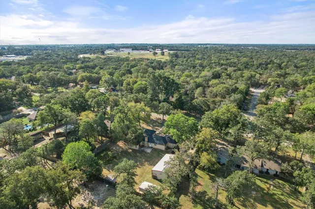 a view of a city with lush green forest