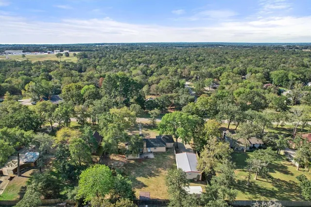 an aerial view of residential houses with city view