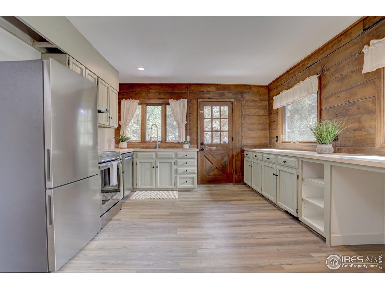601 Pika Road Boulder, CO 80302 - Photo 9 of 38 a kitchen with stainless steel appliances granite countertop a refrigerator a sink dishwasher a oven with white cabinets and wooden floor