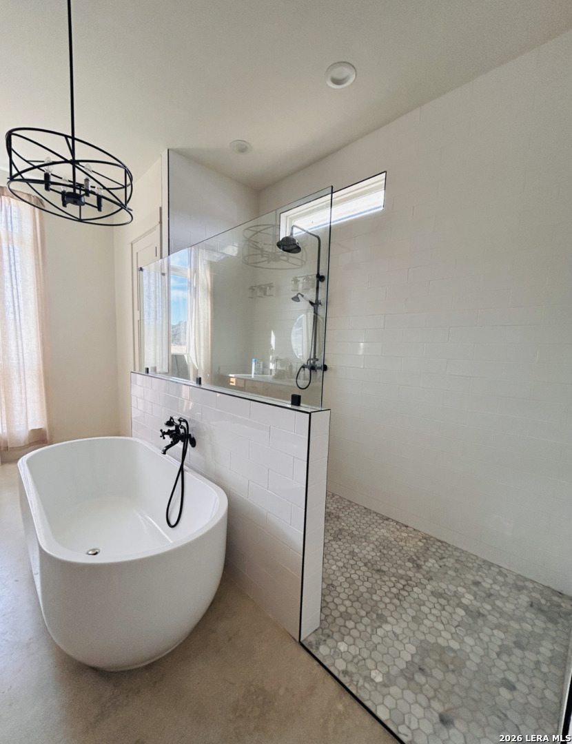 450 Lucky Ridge Bandera, TX 78003 - Photo 5 of 8 a spacious bathroom with a bathtub and shower