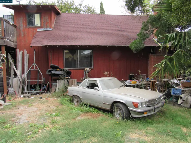 a view of a porch with chairs and backyard