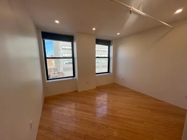 a view of hallway with wooden floor