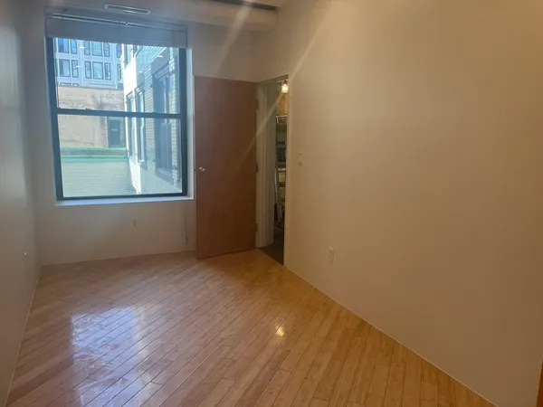 a view of walk in closet with empty racks