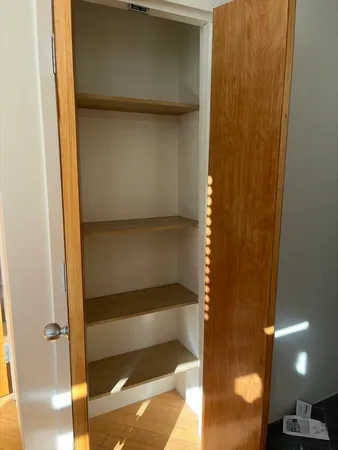 a view of a livingroom with wooden floor and windows