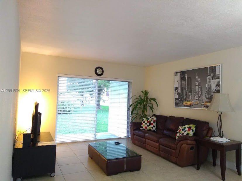 a living room with furniture and a large window