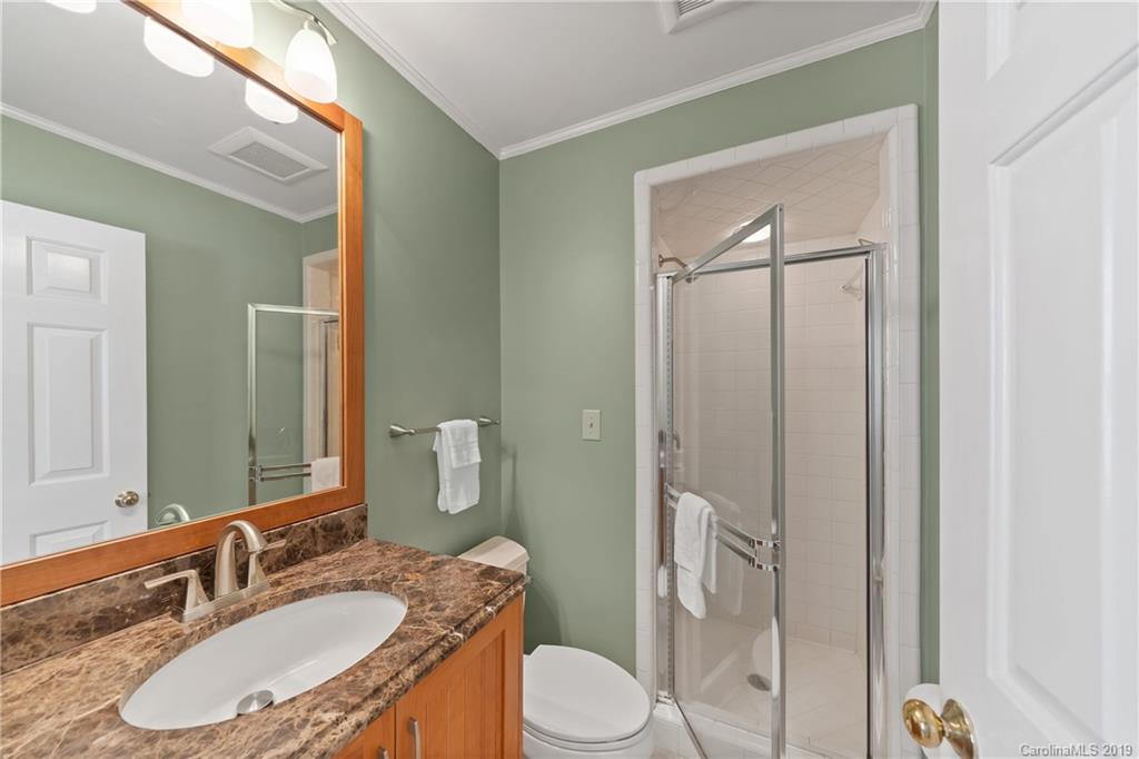445 Cranborne Chase Fort Mill, SC 29708 - Photo 13 of 33 a bathroom with a granite countertop sink toilet a mirror and shower