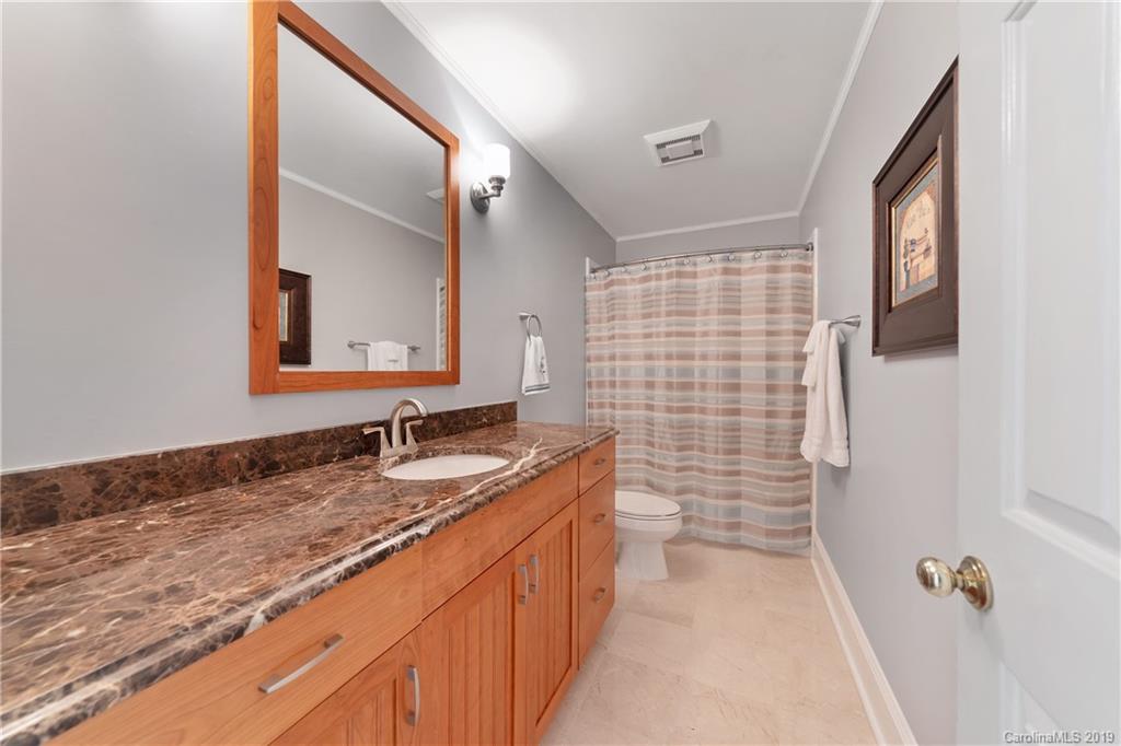 445 Cranborne Chase Fort Mill, SC 29708 - Photo 17 of 33 a bathroom with a granite countertop sink a mirror and a shower