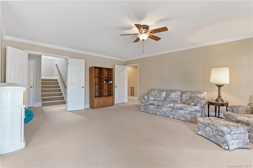 445 Cranborne Chase Fort Mill, SC 29708 - Photo 21 of 33 a living room with furniture and a chandelier