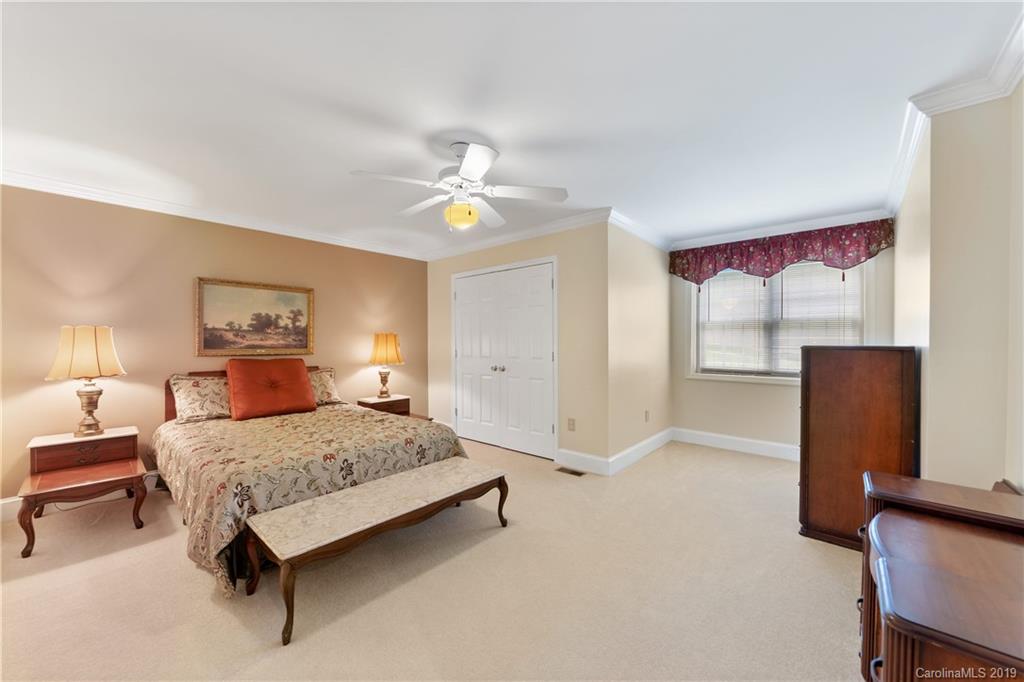 445 Cranborne Chase Fort Mill, SC 29708 - Photo 25 of 33 a bedroom with a bed and a lamp with the dresser
