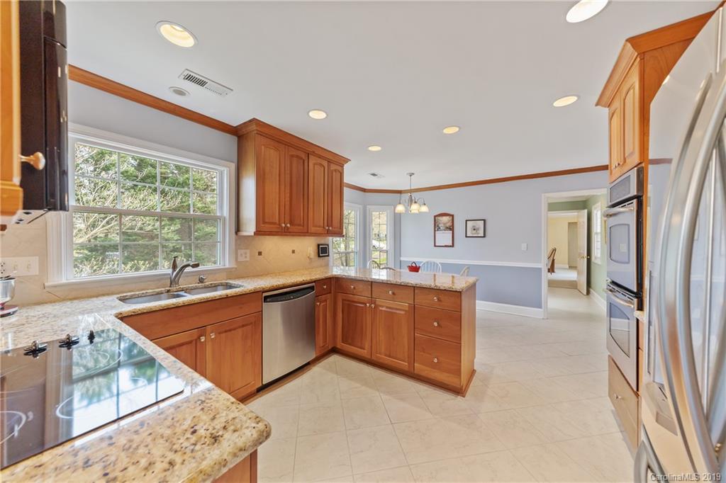 445 Cranborne Chase Fort Mill, SC 29708 - Photo 4 of 33 a kitchen with stainless steel appliances granite countertop a refrigerator and a sink