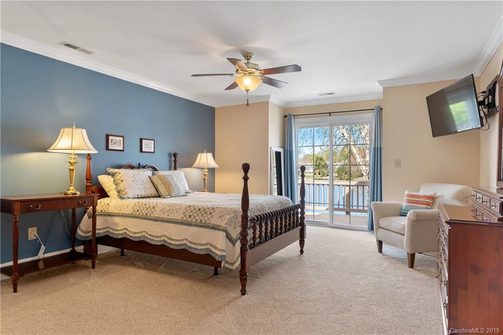 445 Cranborne Chase Fort Mill, SC 29708 - Photo 6 of 33 a spacious bedroom with a bed and a chandelier