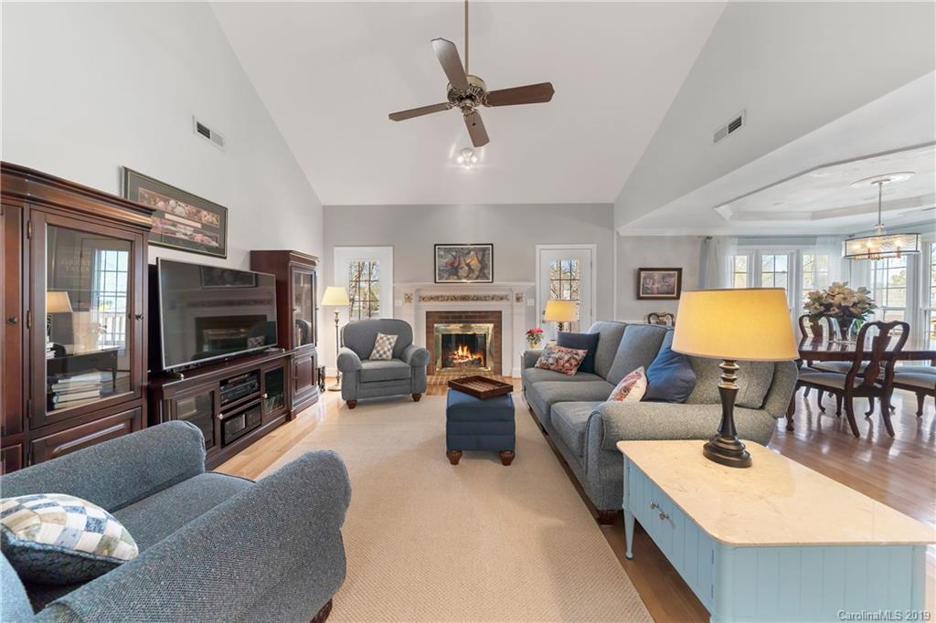 445 Cranborne Chase Fort Mill, SC 29708 - Photo 10 of 33 a living room with furniture a flat screen tv and a fireplace