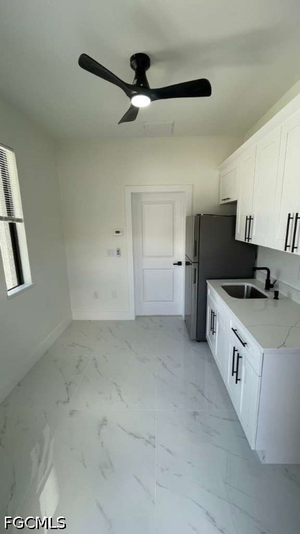 528 Raintree Street East Lehigh Acres, FL 33974 - Photo 5 of 10 a kitchen with a stove a refrigerator and cabinets