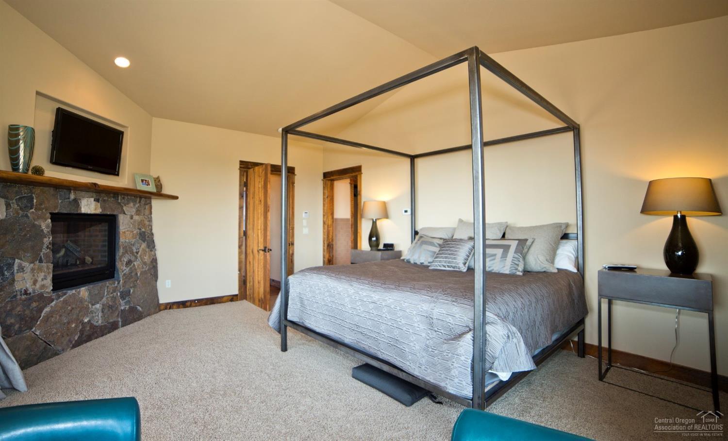 16448 South W Brasada Ranch Road Powell Butte, OR 97753 - Photo 9 of 25 a bedroom with a bed and a flat screen tv