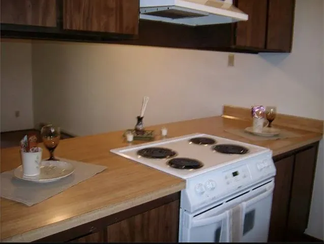 a kitchen with a sink cabinets and appliances