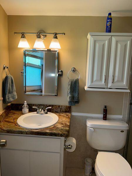 5501 Northwest 2nd Avenue, Unit 310 Boca Raton, FL 33487 - Photo 12 of 23 a bathroom with a sink and a toilet