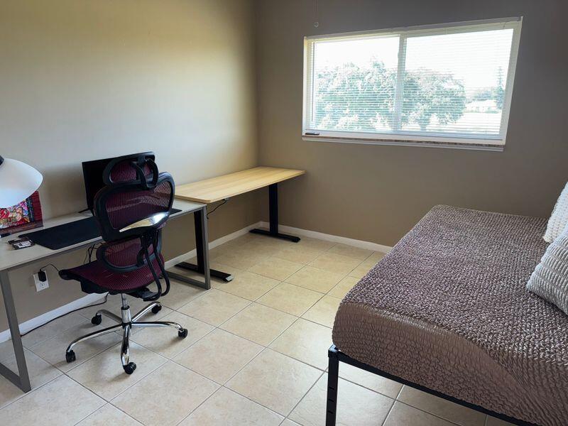 5501 Northwest 2nd Avenue, Unit 310 Boca Raton, FL 33487 - Photo 14 of 23 a bedroom with a workspace