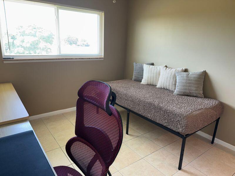 5501 Northwest 2nd Avenue, Unit 310 Boca Raton, FL 33487 - Photo 15 of 23 a bedroom with a bed and a window