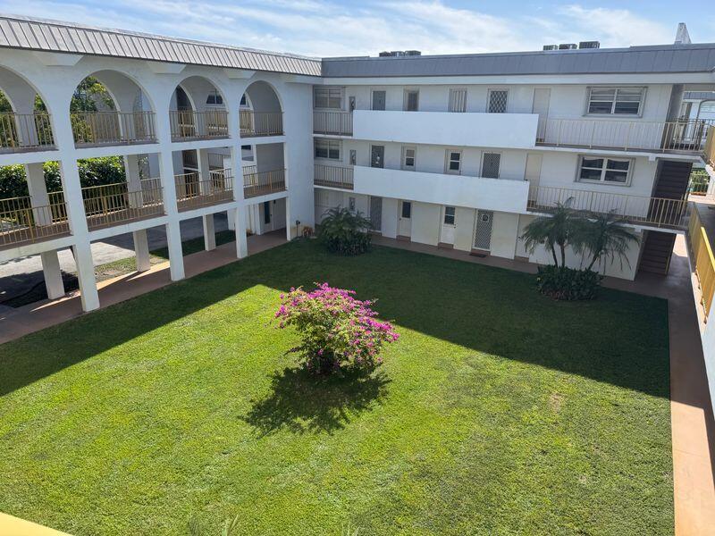 5501 Northwest 2nd Avenue, Unit 310 Boca Raton, FL 33487 - Photo 23 of 23 a view of a house with a yard