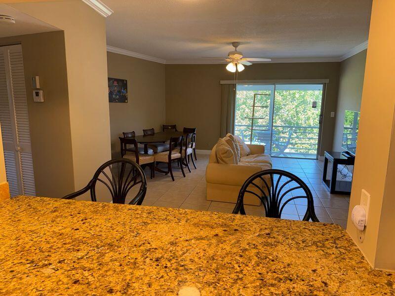 5501 Northwest 2nd Avenue, Unit 310 Boca Raton, FL 33487 - Photo 4 of 23 a bedroom with a bed and large windows