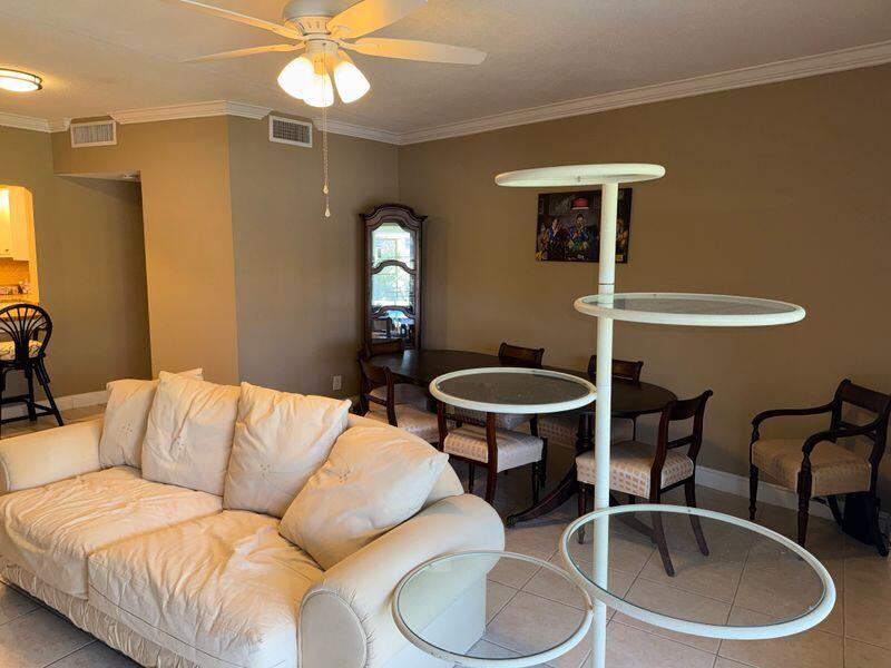5501 Northwest 2nd Avenue, Unit 310 Boca Raton, FL 33487 - Photo 6 of 23 a living room with furniture a window and a lamp