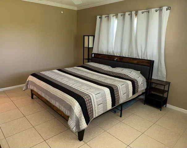 a bed sitting in a bedroom next to a window