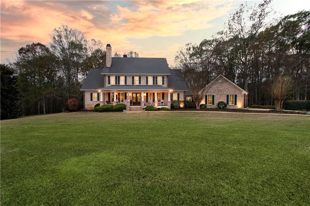 a front view of house with yard and green space