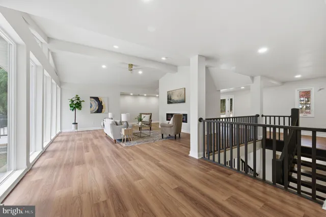 a large kitchen with stainless steel appliances a large counter top a stove a sink and a refrigerator