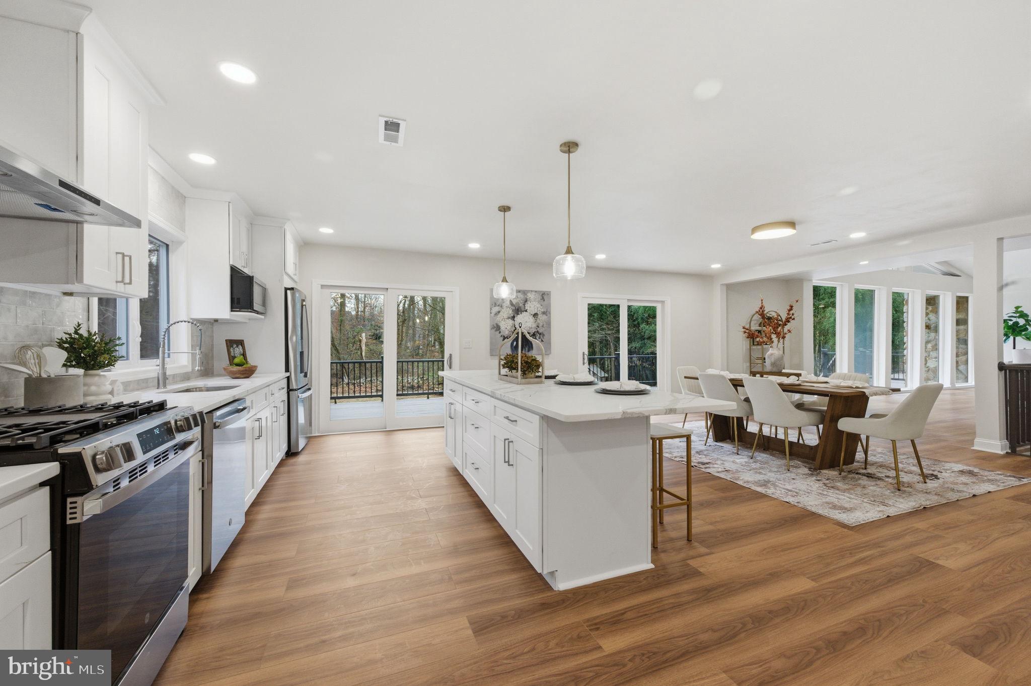 4 Meteor Lane Newark, DE 19711 - Photo 14 of 56 a large kitchen with stainless steel appliances a large counter top a stove a sink and a refrigerator