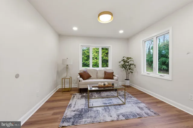 a view of hallway with wooden floor and windows