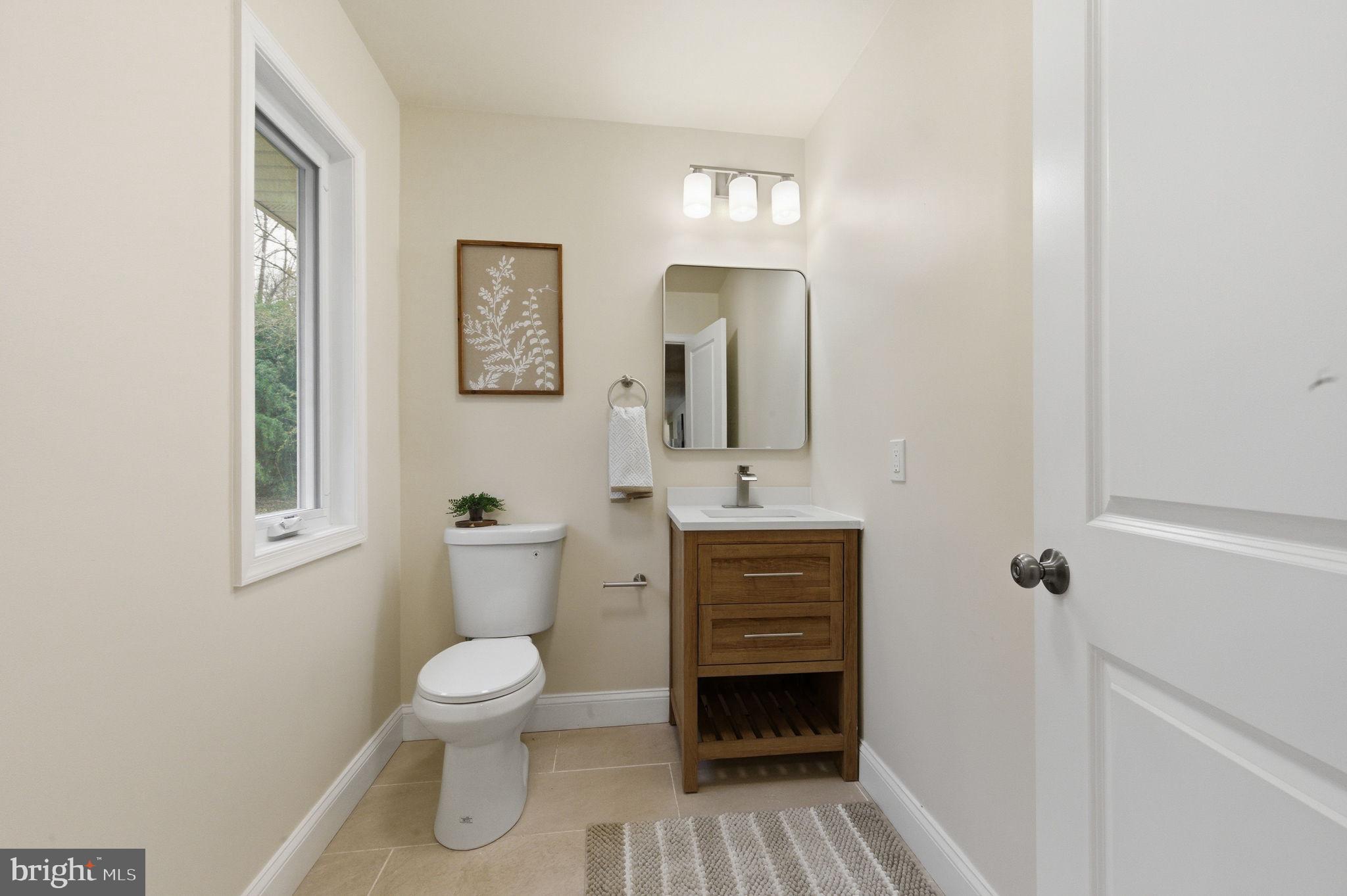 4 Meteor Lane Newark, DE 19711 - Photo 19 of 56 a bathroom with a toilet a sink and mirror