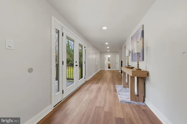 a view of hallway with wooden floor