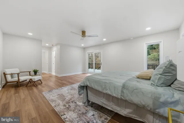 a spacious bedroom with a bed and wooden floor