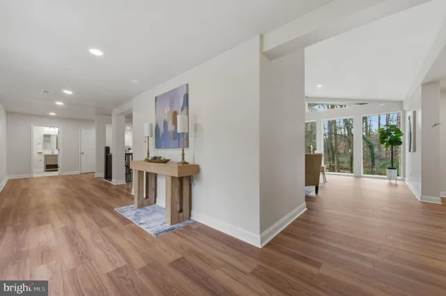 a view of a big room with wooden floor and windows