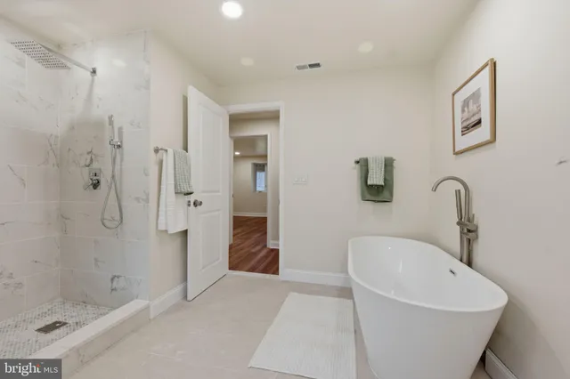 a view of a room with wooden floor and white walls