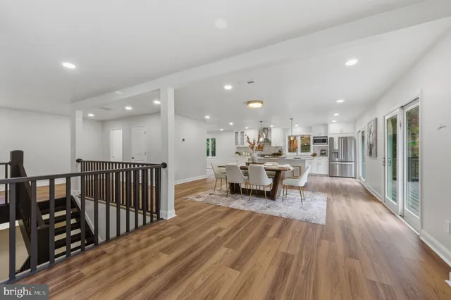 a view of a living room filled with furniture and wooden floor