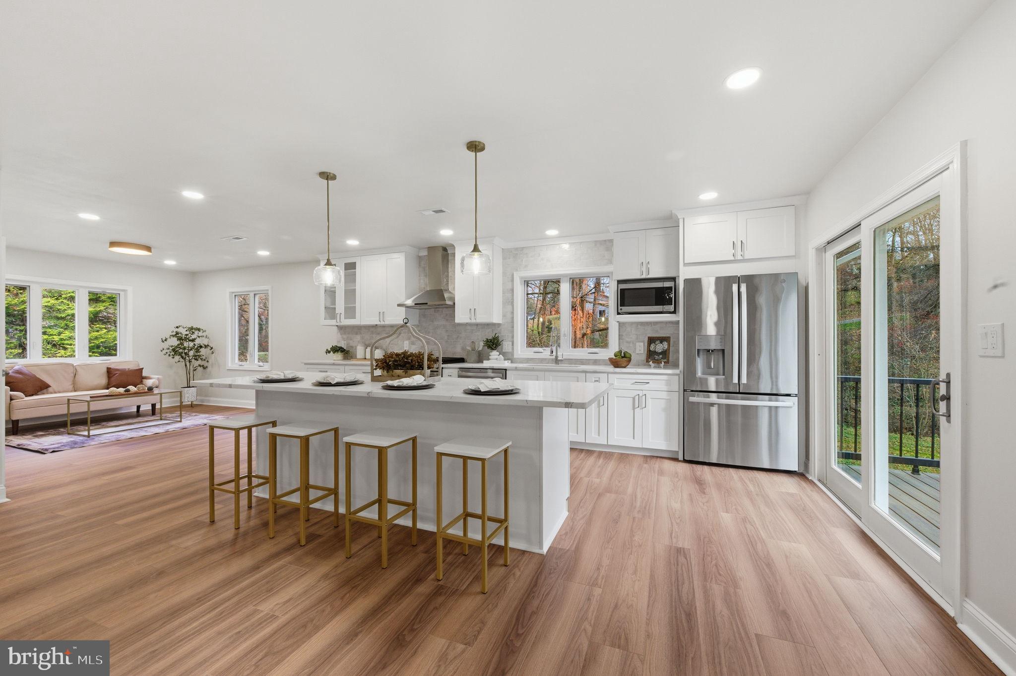 4 Meteor Lane Newark, DE 19711 - Photo 10 of 56 a kitchen with stainless steel appliances granite countertop a refrigerator a stove top oven a sink dishwasher and white cabinets with wooden floor