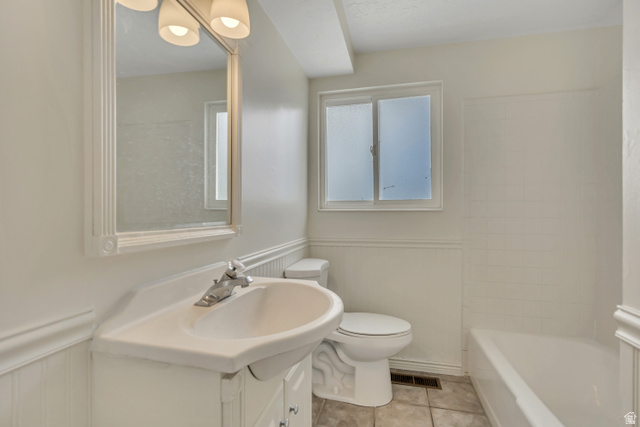 3166 Linden Street Bountiful, UT 84010 - Photo 7 of 25 Bathroom featuring a wainscoted wall, vanity, light tile patterned floors, and a decorative wall