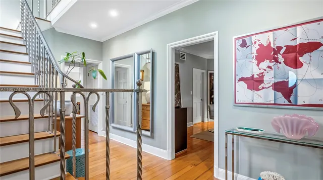a view of a livingroom with furniture wooden floor and a large window