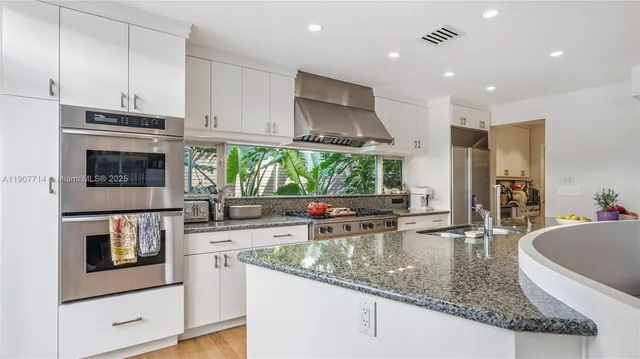 a white toilet sitting next to a bathroom sink